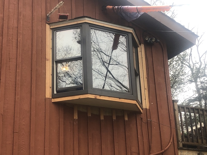 Pella bay wind with a custom roof and cedar trim installed by WIndow Solutions Plus